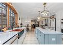 Bright, open kitchen with a large island, stainless appliances, and a decorative copper farmhouse sink at 689 Red Deer Rd, Franktown, CO 80116