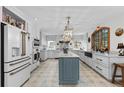 Spacious kitchen with a center island, stainless steel appliances, and white cabinetry for ample storage at 689 Red Deer Rd, Franktown, CO 80116