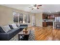 Inviting living room with ample natural light, hardwood floors, and an open floor plan at 10247 Telluride Way, Commerce City, CO 80022