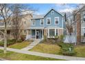 Beautiful two-story home with a covered front porch and brick detailing at 7860 E Ellsworth Ave, Denver, CO 80230