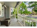 Inviting covered front porch offers relaxing outdoor seating with views of the neighborhood at 7860 E Ellsworth Ave, Denver, CO 80230