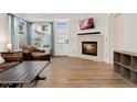 Cozy living room featuring a tiled fireplace and hardwood floors at 7860 E Ellsworth Ave, Denver, CO 80230
