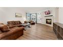 Inviting living room with a modern fireplace and hardwood floors at 7860 E Ellsworth Ave, Denver, CO 80230