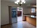 Bright dining area with sliding glass doors to patio and adjoining updated kitchen at 12640 W Virginia Ave, Lakewood, CO 80228