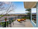 Relaxing back deck area featuring stylish lounge chairs and mountain views at 11551 W 103Rd Dr, Broomfield, CO 80021