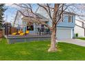 Charming home exterior with inviting deck, lush lawn, and a well-maintained yard at 11551 W 103Rd Dr, Broomfield, CO 80021