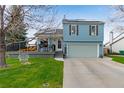 Two-story home featuring a lovely front yard, deck and convenient two car garage at 11551 W 103Rd Dr, Broomfield, CO 80021