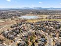 Aerial view of a neighborhood with homes near a lake and golf course in a suburban area at 2730 River View Dr, Broomfield, CO 80023