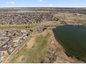 An aerial view shows the property is nestled near a lake, golf course, and athletic fields at 2730 River View Dr, Broomfield, CO 80023