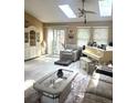 Bright living room with skylights, neutral tones, and comfortable seating at 6833 S Miller St, Littleton, CO 80127