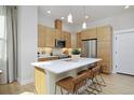 Modern kitchen featuring sleek cabinets, stainless steel appliances, a central island with a white countertop, and stylish seating at 2855 S Pancratia St, Denver, CO 80236