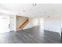 Open-concept living area featuring sleek floors and natural light from the entry door at 3608 W Radcliff Ave, Denver, CO 80236