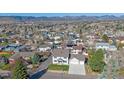 Inviting two-story home boasts a well-manicured lawn and an attached two-car garage at 8225 S Cody St, Littleton, CO 80128