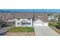 Charming two-story home with a well-maintained lawn and a convenient two-car garage at 8225 S Cody St, Littleton, CO 80128