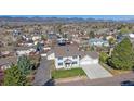 Inviting two-story home boasts a well-manicured lawn and an attached two-car garage at 8225 S Cody St, Littleton, CO 80128