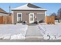 Exterior front view of home with light gray vinyl siding and charming white trim at 402 Harrison Ave, Fort Lupton, CO 80621