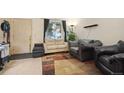Inviting living room with plush seating, neutral walls and modern rug at 17664 E Loyola Dr # C, Aurora, CO 80013