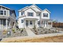 New construction two-story home with gravel landscaping and covered porch at 1374 Penner Dr, Erie, CO 80026