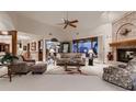 Inviting living room with a brick fireplace, large windows, plush seating, and soft, neutral carpeting at 7769 W 70Th Dr, Arvada, CO 80004