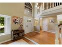 Elegant foyer with soaring ceilings, hardwood floors, and abundant natural light, creating a grand entrance at 12 Long Spur, Littleton, CO 80127