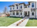 Charming home exterior featuring a lush green lawn, stone accents, and a welcoming walkway to the front entrance at 1640 Winona Ct, Denver, CO 80204