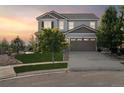 A classic two-story home with a three-car garage, nestled in a serene neighborhood at sunset at 3741 Harvard Pl, Broomfield, CO 80023