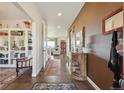 Elegant foyer featuring hardwood floors, sophisticated decor, and a glimpse into the inviting living spaces at 3741 Harvard Pl, Broomfield, CO 80023