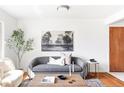 Cozy living room featuring modern furniture and decor with hardwood floors and decorative rug at 6580 Independence Way, Arvada, CO 80004