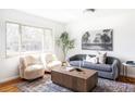Cozy living room with bright window, featuring modern furniture and decor with hardwood floors and decorative rug at 6580 Independence Way, Arvada, CO 80004
