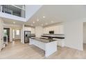 Open kitchen with stainless steel appliances and large center island at 39857 Floyd St, Elizabeth, CO 80107