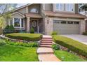 Inviting home entrance with landscaped front yard and a welcoming walkway leading to the front door at 17038 Lamar Dr, Parker, CO 80134