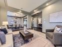 Open-concept view showcasing a formal living room leading into the dining area with dark wood floors at 1648 Exquisite St, Castle Rock, CO 80109