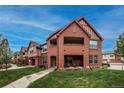 View of the condos from across a grassy lawn, highlighting architectural details at 1379 Charles # 4, Longmont, CO 80503