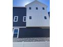 A modern home featuring blue siding and white accents, showcasing contemporary architectural design at 2140 S Haleyville Way, Aurora, CO 80018