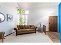 Inviting living room featuring a cozy couch, large window with natural light, and tasteful decor at 750 S Dearborn Ct, Aurora, CO 80012