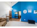 Vibrant living room showcases an accent wall, wood floors, stylish console table and comfortable couch at 750 S Dearborn Ct, Aurora, CO 80012
