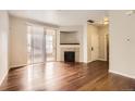 Spacious living room with a fireplace, sliding glass doors, and hardwood floors perfect for relaxation and entertainment at 4100 Albion St # 303, Denver, CO 80216