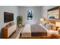 Cozy bedroom featuring a comfortable bed, modern dresser, and stylish decor at 9645 W 73Rd Pl, Arvada, CO 80005