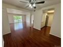 Open-concept living room with hardwood floors flows seamlessly into the updated kitchen at 12166 Melody Dr # 202, Denver, CO 80234