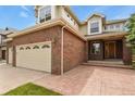 Attractive home featuring a brick exterior, three-car garage, and well-manicured lawn at 6533 S Ouray St, Aurora, CO 80016