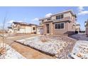 Charming front exterior of the home with a two car garage and neutral-colored siding at 9122 Telluride Ct, Commerce City, CO 80022