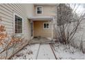 Cozy back patio with a covered porch and snow-covered walkway, great for outdoor relaxation at 2466 S Vaughn Way # A, Aurora, CO 80014