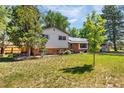 Charming two-story home with brick and siding exterior and a well-manicured lawn at 12475 W 38Th Ave, Wheat Ridge, CO 80033