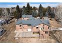 Aerial view of the house and driveway area with mature trees on the lot at 3720 E Quincy Ave, Cherry Hills Village, CO 80113