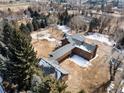 Aerial view of brown two-story home with glass enclosed walkway connecting the two buildings at 3720 E Quincy Ave, Cherry Hills Village, CO 80113