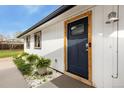 Stylish front door with tasteful accents and landscaping, creating a welcoming entryway at 720 Independence Dr, Longmont, CO 80504