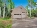 Detached garage with multiple doors, offering ample space for vehicles and storage at 2654 Sinton Rd, Evergreen, CO 80439