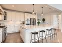 Spacious kitchen with island, stainless steel appliances, and hardwood floors at 579 Backcountry Ln, Highlands Ranch, CO 80126