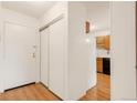 Entryway with a closet and wood floors leading into the kitchen at 13606 E Bates Ave # 309, Aurora, CO 80014