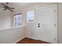 Bright foyer featuring wood floors, a large white door and a modern ceiling fan at 749 Westward Ln, Palmer Lake, CO 80133